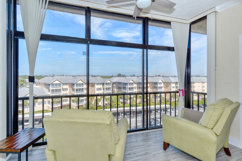 Your private balcony features comfortable seating where you can unwind with panoramic views of the residential community below.