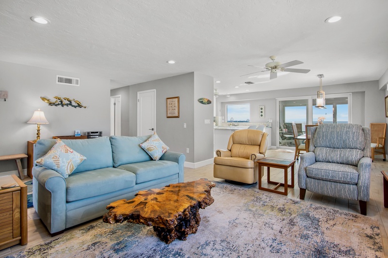 Sink into plush seating while ocean breezes flow through your bright, coastal living room featuring stunning sea views and thoughtful touches.