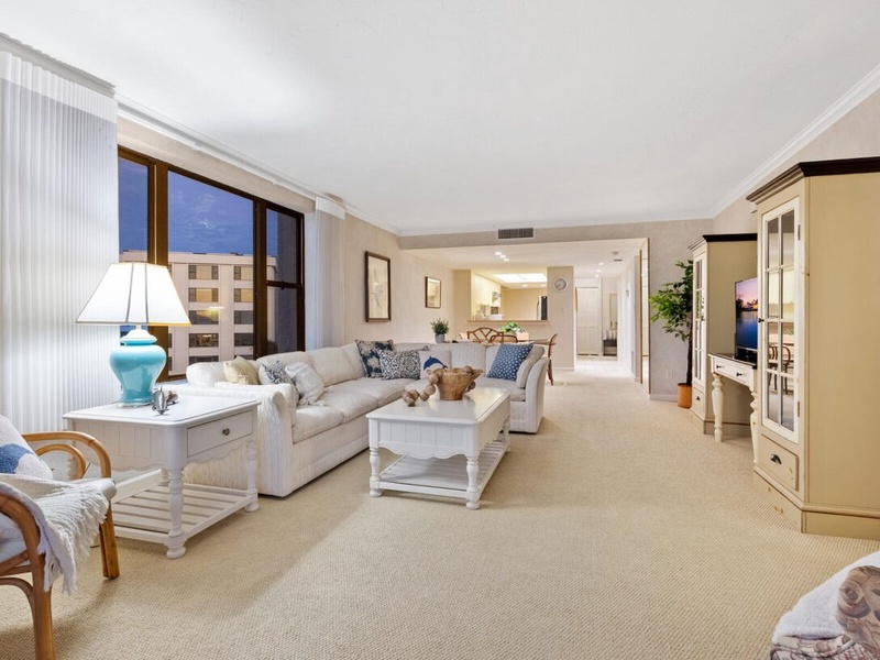 Unwind in your spacious living room with plush seating, natural light, and coastal-inspired decor creating the perfect retreat.