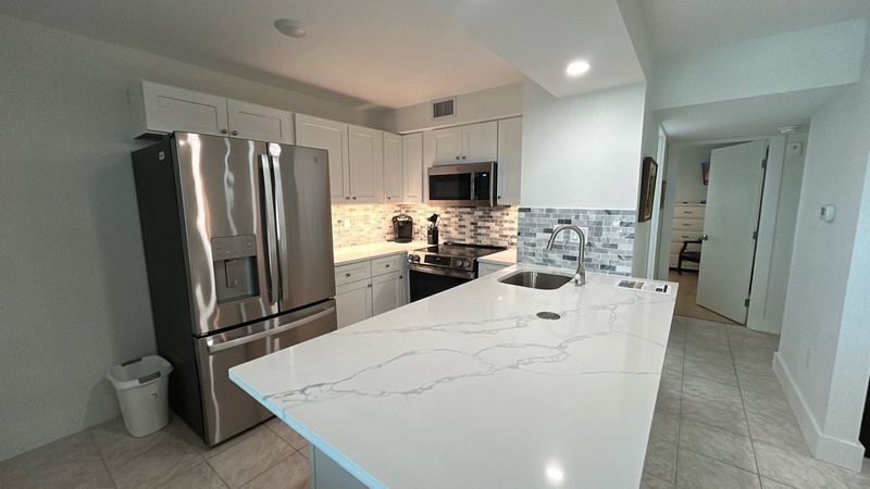 Cook your favorite meals in this stunning modern kitchen featuring granite countertops, stainless steel appliances, and ample prep space.