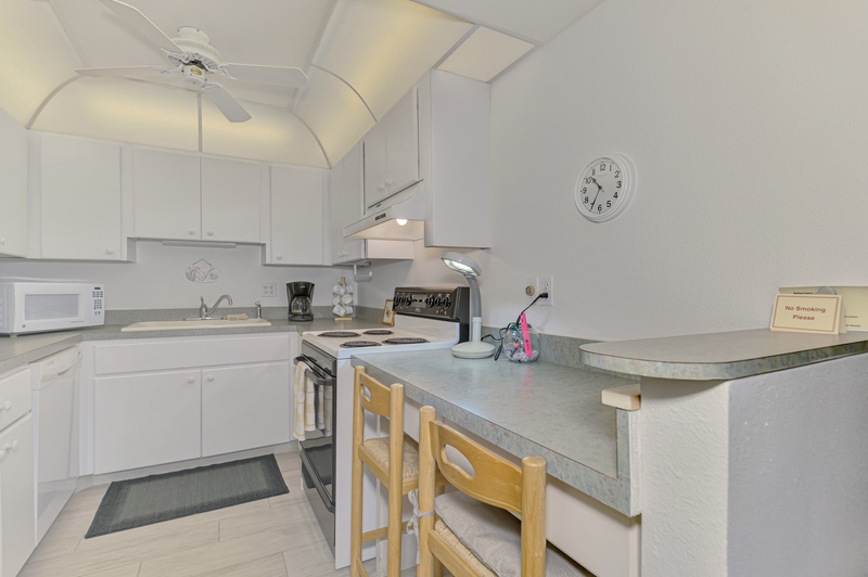 Your bright, fully-equipped kitchen invites culinary adventures with modern appliances and a cozy breakfast bar for casual meals.