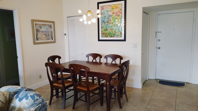 Gather around your elegant dining table for memorable meals, with artwork and modern lighting creating a warm atmosphere.