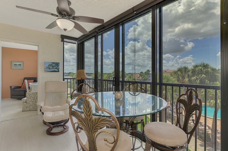 Your private screened balcony offers the perfect spot for morning coffee with tropical palm views and refreshing breezes.