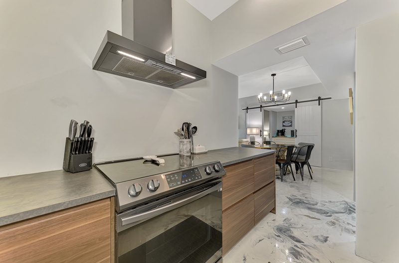 Your sleek kitchen island features modern appliances and granite countertops, perfect for preparing memorable meals during your stay.