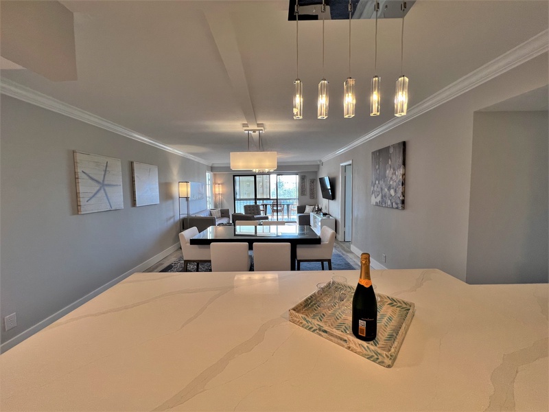 Unwind in your elegant open-concept living space where modern lighting and sophisticated décor create the perfect atmosphere for memorable evenings with loved ones.