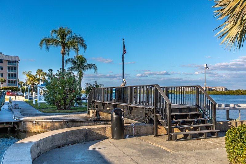 Waterfront boardwalk with marina access and tropical palms creates an inviting coastal setting for your Florida getaway.