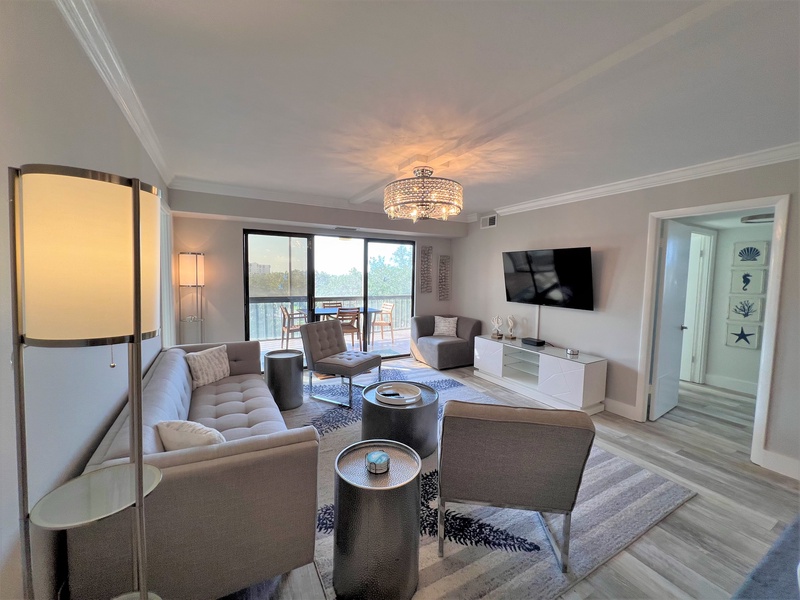 Sink into the plush sofa and enjoy your favorite shows on the wall-mounted TV while natural light streams through the balcony doors.