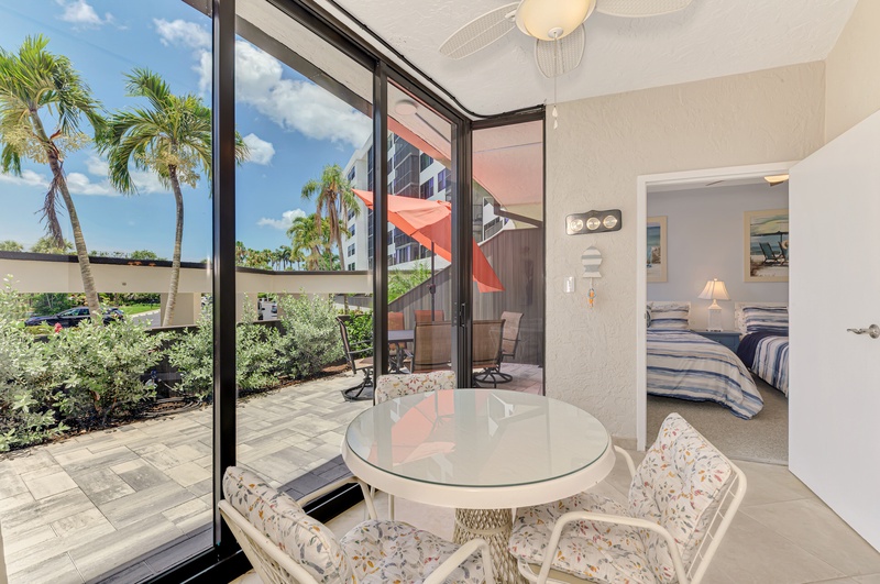 Enjoy morning coffee at your private dining nook with tropical garden views and seamless access to your outdoor terrace.