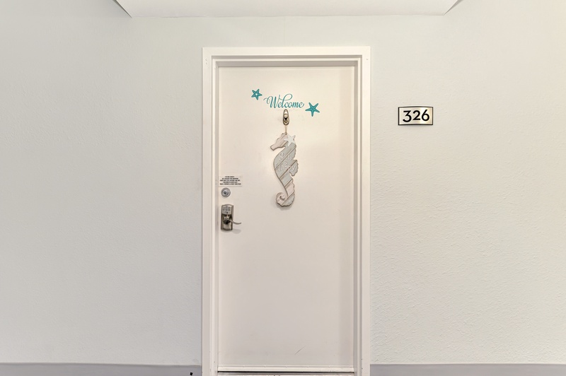 Step into room 326, where a cheerful welcome decoration greets you at your door, setting the tone for your comfortable stay.