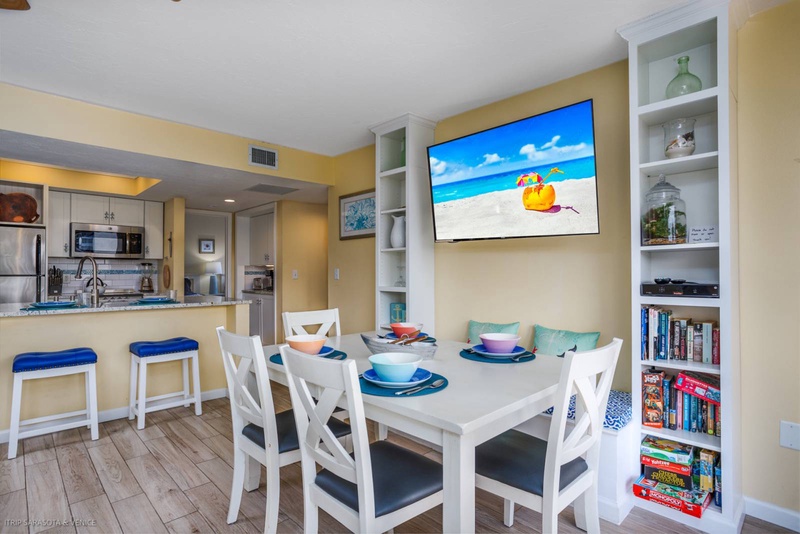 Your coastal retreat features an open dining area with beach views on TV, perfect for family meals and game nights.