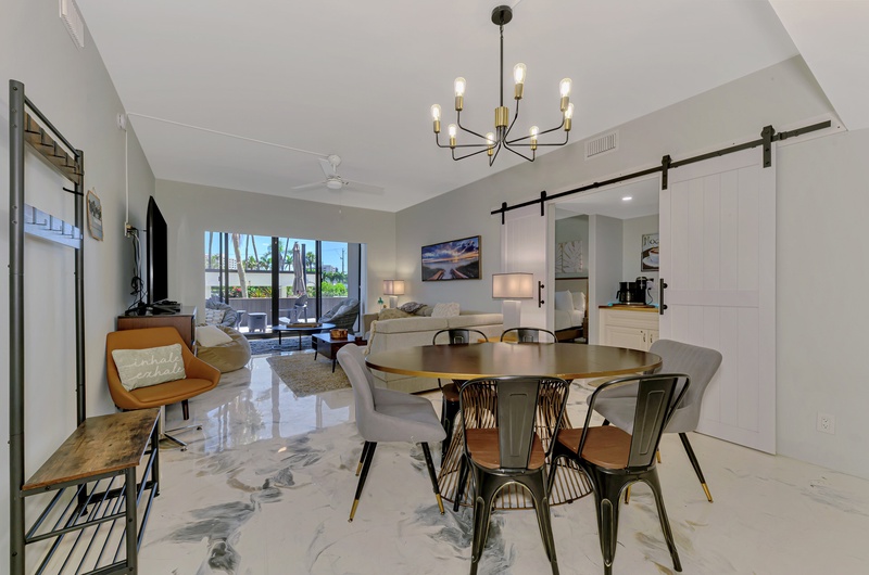 Unwind in your stylish open-plan living space with modern furnishings, elegant lighting, and sleek marble floors creating the perfect atmosphere for relaxation.