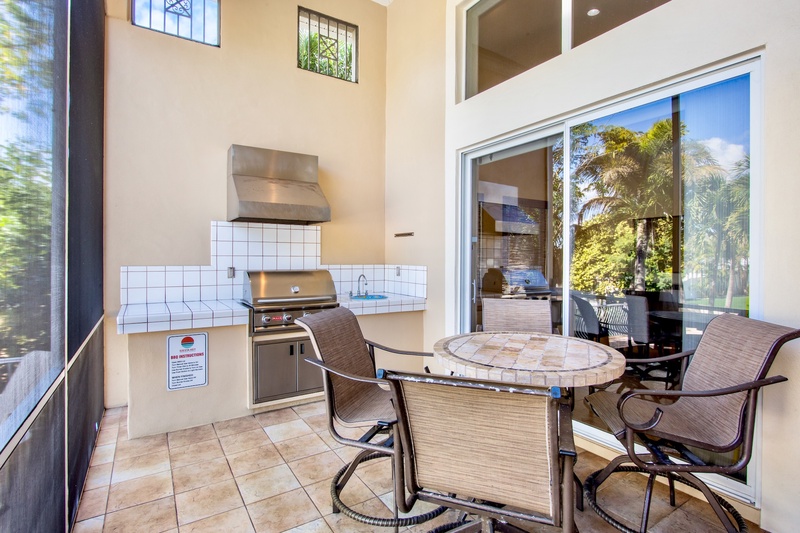 Screened-in lanai with built-in BBQ and dining area