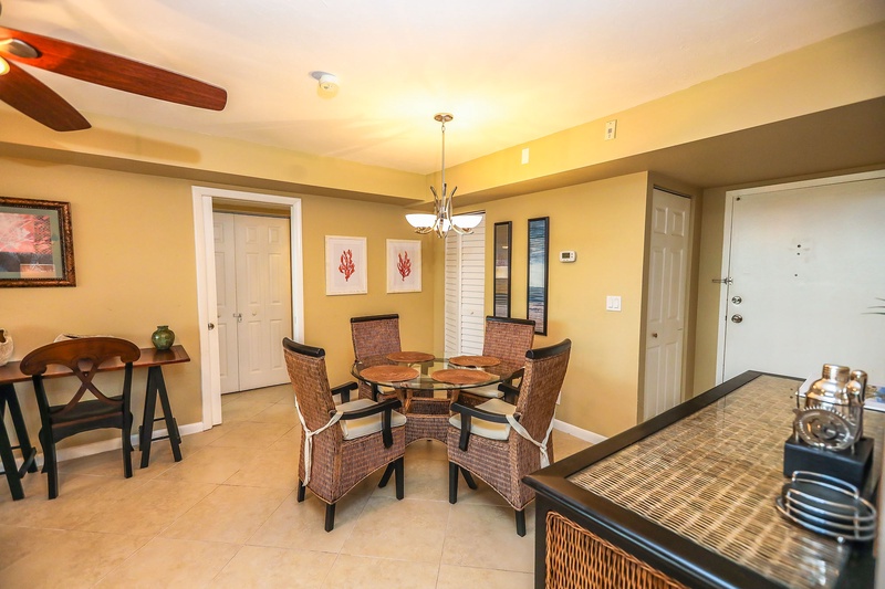 Gather around your elegant dining table for memorable meals in this warm, coastal-themed space with comfortable wicker seating.