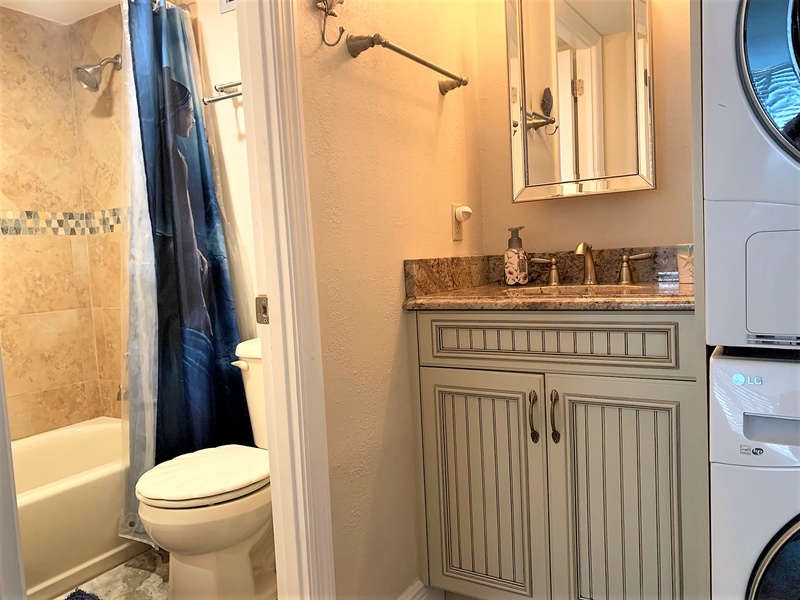 Your private bathroom features elegant granite countertops and thoughtful finishes, with convenient laundry facilities right at your fingertips.