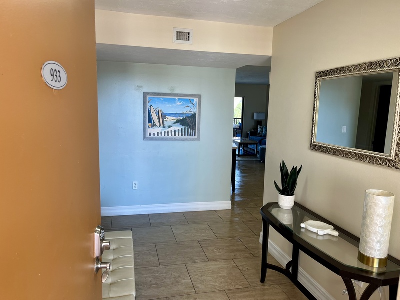 Step into your welcoming entryway with coastal artwork and thoughtful touches that immediately make you feel at home.