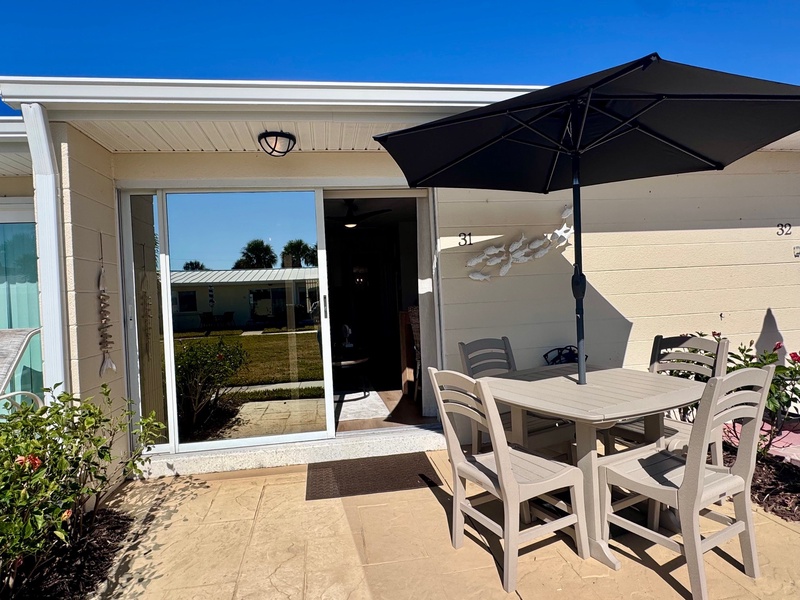 Step onto your private patio where morning coffee and sunset dinners await under the shade of your personal umbrella.