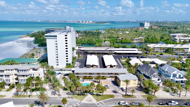 Stunning beachfront resort complex with turquoise waters and pristine white sand beaches stretching along the coast.