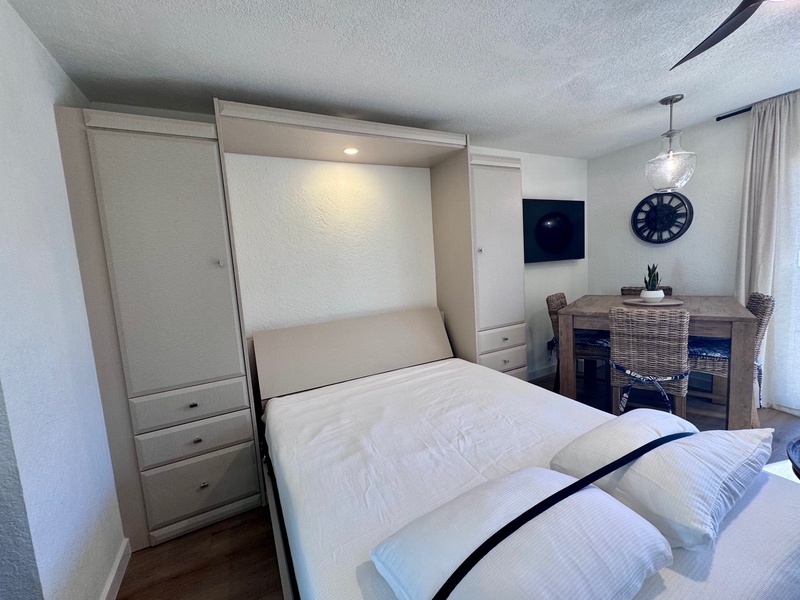 Your cozy retreat features a space-saving Murphy bed and dining area, perfect for relaxing after exploring the city.
