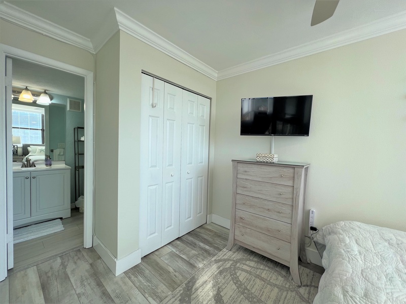 Your bedroom features a wall-mounted TV for cozy evening entertainment, while the en-suite bathroom awaits just steps away.