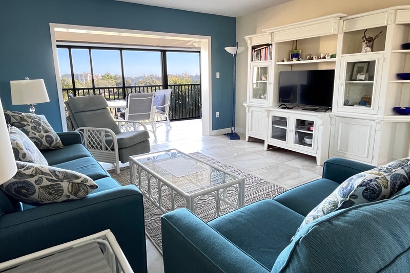 Relax in this bright living room where coastal colors meet comfort. Sink into plush seating while enjoying mountain views from your private balcony.