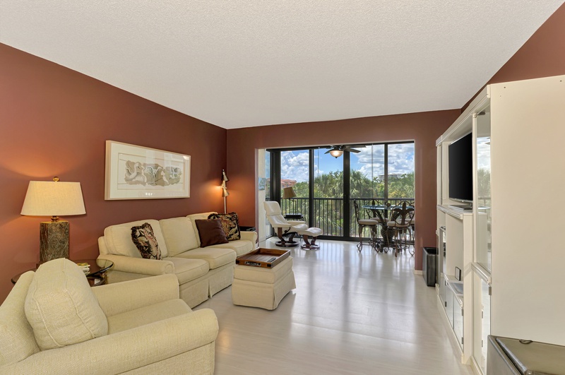 Relax in your spacious living room where warm earth tones and comfortable seating create the perfect retreat after exploring.