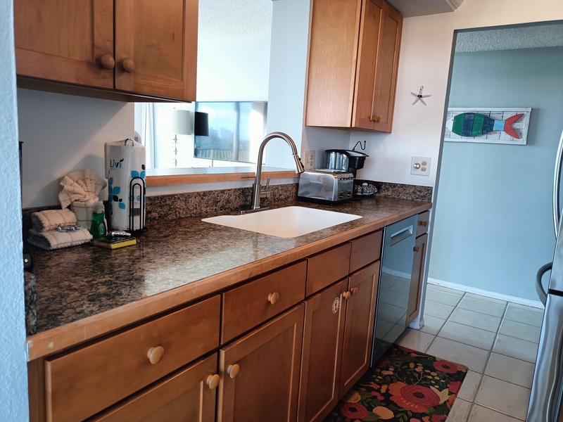 Your fully equipped kitchen features granite counters, dishwasher, and everything needed to prepare meals during your coastal getaway.