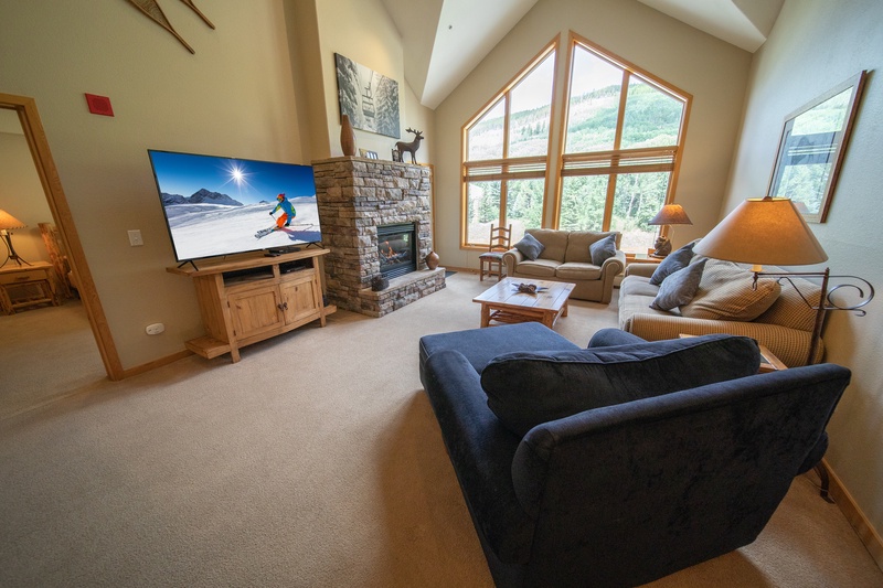 Living room with cozy fireplace and large windows