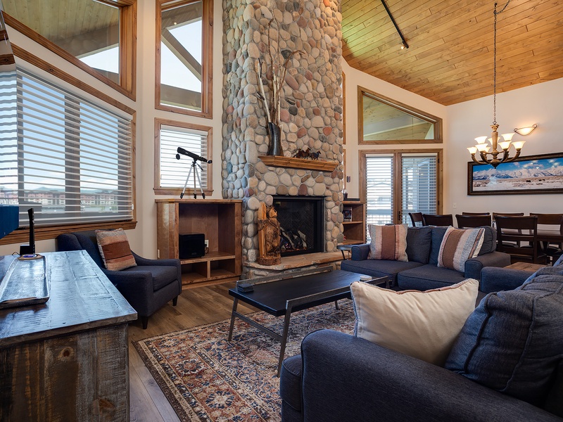 Gather by the towering stone fireplace or sink into plush seating with cathedral ceilings and warm wood surrounding you. Your mountain escape awaits in this inviting great room.