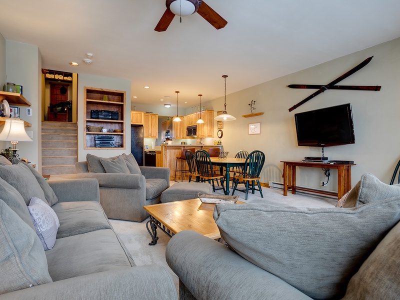 Unwind in your spacious living area with plush sofas, ceiling fans, a big-screen TV, and an open layout that flows into the fully-equipped kitchen and dining space—perfect for relaxing after a day of adventure.