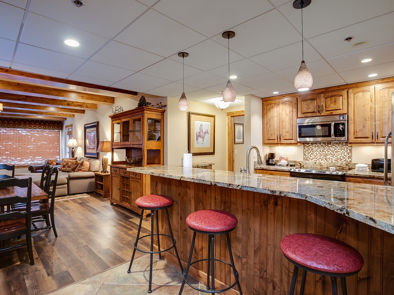 Gather around the spacious kitchen island with granite countertops and modern appliances, or relax in the open living and dining area—perfect for memorable meals and cozy evenings together.