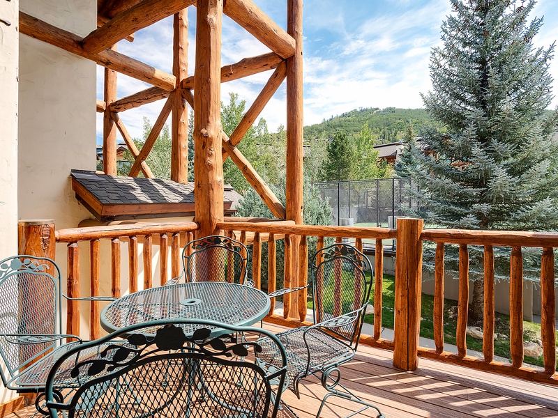 Step onto your private terrace and breathe in the crisp mountain air. This outdoor seating area invites you to unwind with morning coffee or evening wine, surrounded by evergreens and alpine views.