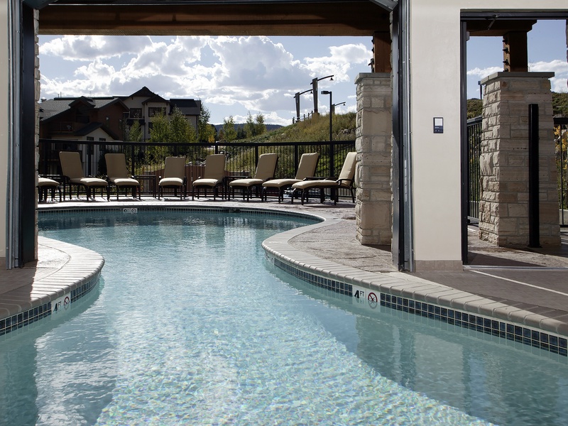 Your private poolside sanctuary awaits, with cushioned loungers and mountain views framing every moment. Step outside to bask in the sun, take a refreshing dip, or simply unwind under open skies.