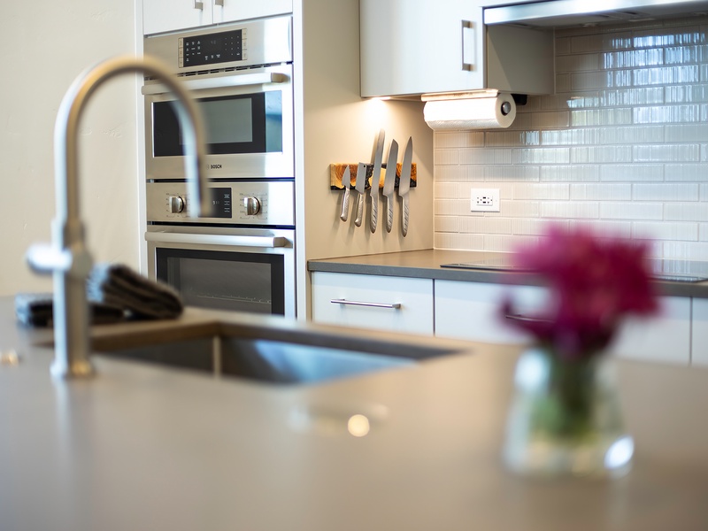 Your gourmet kitchen awaits, featuring sleek modern appliances, bright tile backsplash, and every tool you need to prepare memorable meals during your stay.