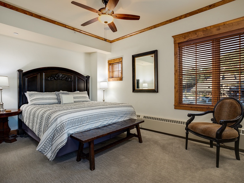 Sink into crisp linens and drift off under the gentle breeze of your ceiling fan, while warm wood accents and soft lighting wrap you in comfort.