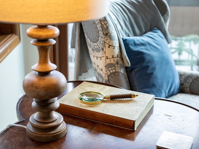 Curl up with your favorite book in this inviting seating area, where soft pillows and warm lamplight create the perfect reading nook for your stay.