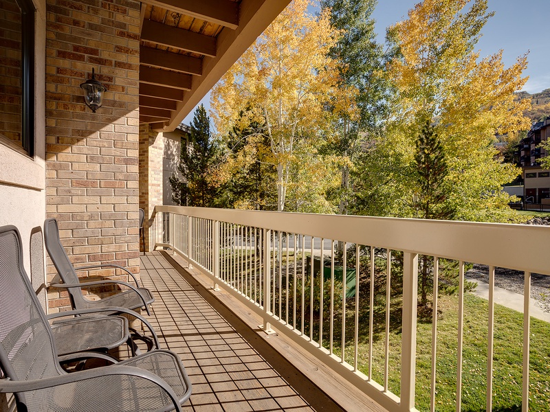 Step onto your private balcony and take in vibrant autumn foliage framing mountain views. Unwind in comfy lounge chairs while crisp air and golden leaves create the perfect escape.