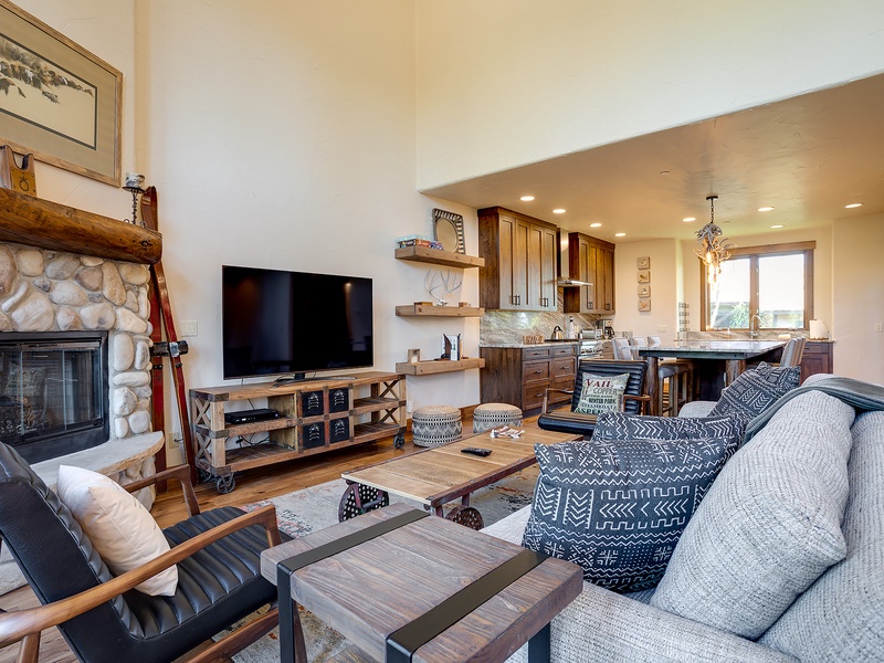 Unwind in this open-concept living space, where a cozy stone fireplace and mountain-inspired décor invite you to relax after a day of adventure. Your perfect retreat awaits.