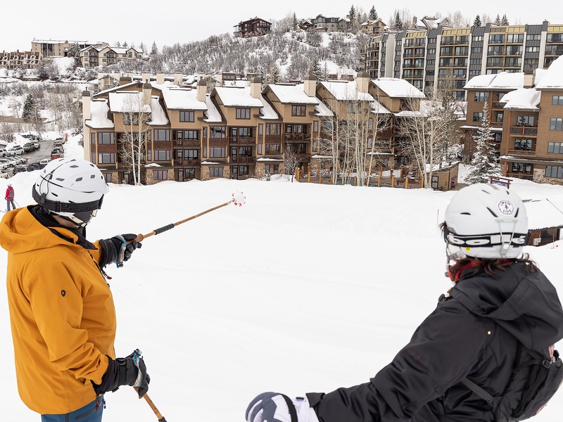 This slope-side location places the property at the heart of a ski village, with surrounding accommodations and snowy slopes defining the winter resort area.