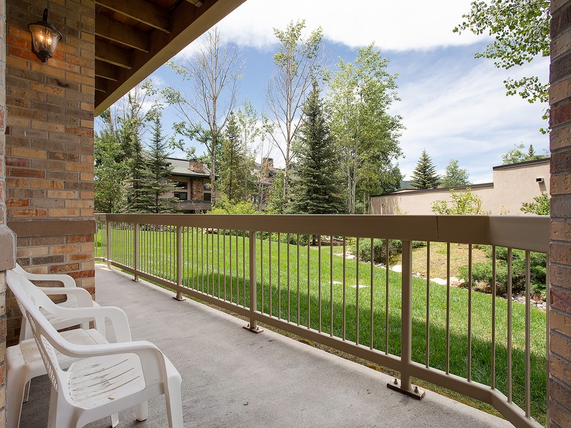 Unwind on your private balcony overlooking lush green lawns and mature trees—a perfect spot for morning coffee or evening relaxation in peaceful surroundings.