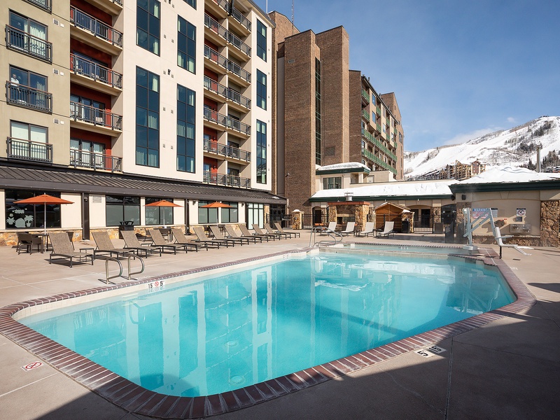 Modern mountain resort with heated outdoor pool, sunbeds, and scenic slopes nearby—perfect for a refreshing dip after a day on the mountain.