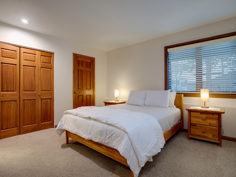 Slip into crisp linens and unwind in your serene bedroom, where warm wood tones and soft lighting create the perfect retreat after your mountain adventures.