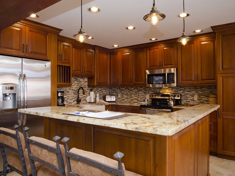 Picture yourself cooking your favorite meals in this beautifully appointed kitchen. Rich wood cabinetry, gleaming granite countertops, and modern stainless-steel appliances await your culinary adventures.