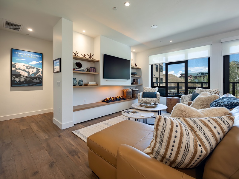 Sink into plush seating and enjoy your favorite shows in this bright, inviting living room with mountain views framing your stay.