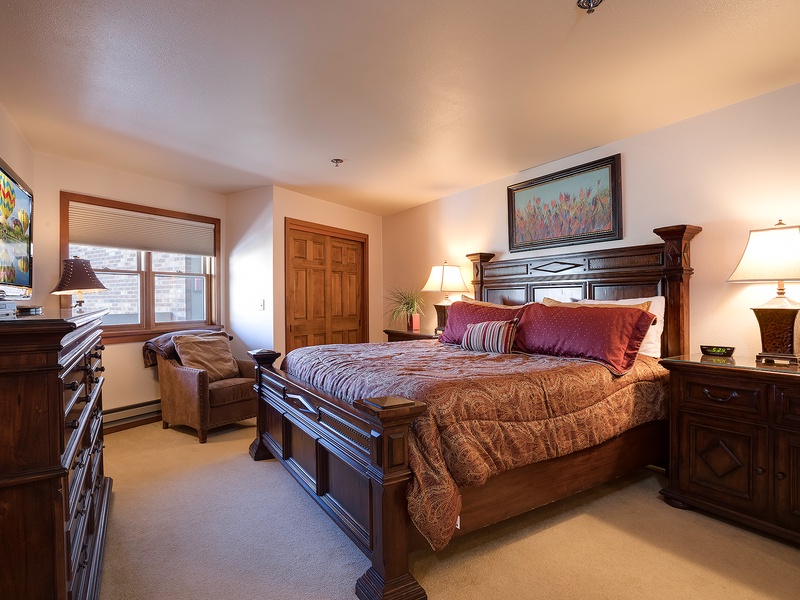 Sink into your cozy king bed surrounded by rich wood tones and soft lighting. Enjoy your favorite shows on the flat-screen TV and unwind in this welcoming retreat.