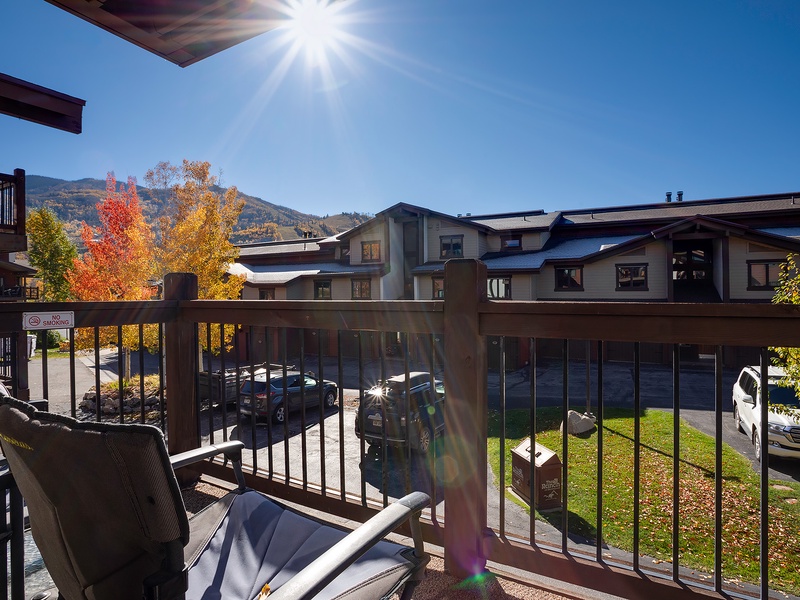 The property is situated in a scenic mountain area with vibrant autumn foliage, offering convenient parking and access to the surrounding neighbourhood during the fall season.