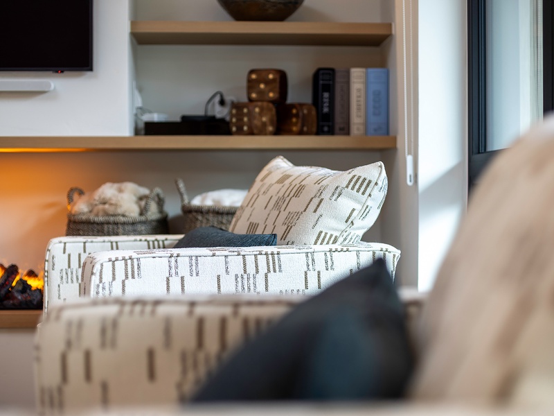 Sink into plush seating surrounded by warm textures and glowing ambient light—your cozy retreat awaits after a day of adventure.