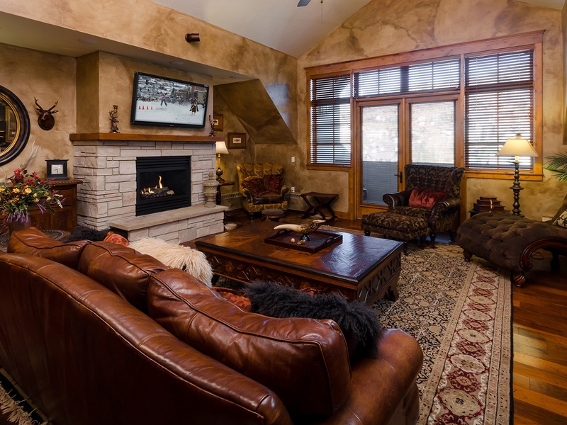 Sink into rich leather seating by your private stone fireplace, where warm wood tones and mountain elegance create the perfect retreat after your adventures.