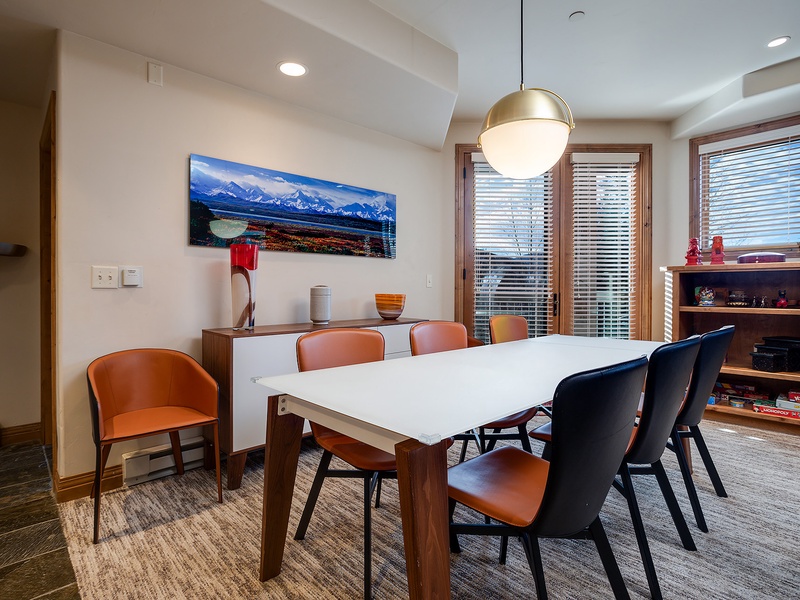 Gather around this stylish dining table with mountain views. The warm wood tones and modern chairs create the perfect spot for memorable meals together.