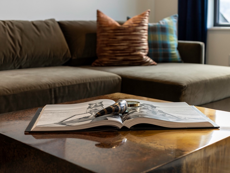 Settle into the plush sofa with a good book and soft natural light—your perfect spot to unwind after a day of exploring.