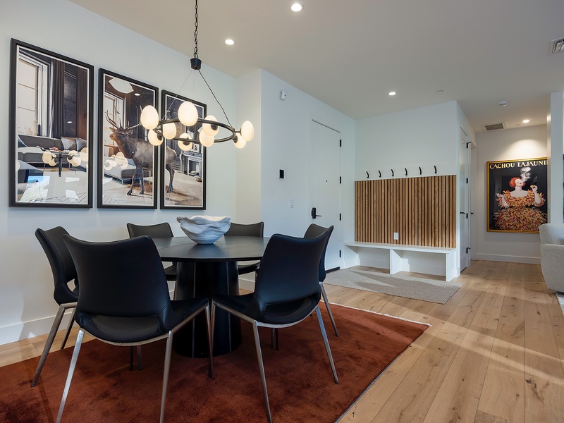 Gather around this sleek dining table for shared meals and conversation, warmed by modern lighting and tasteful art that makes your vacation home feel stylish and welcoming.